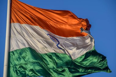 India flag flying high at Connaught Place with pride with plain white background, India flag fluttering, Indian Flag on Independence Day and Republic Day of India, tilt up shot, Har Ghar Tiranga