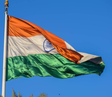 India flag flying high at Connaught Place with pride with plain white background, India flag fluttering, Indian Flag on Independence Day and Republic Day of India, tilt up shot, Har Ghar Tiranga