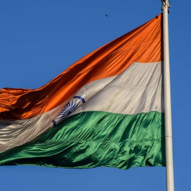 India flag flying high at Connaught Place with pride with plain white background, India flag fluttering, Indian Flag on Independence Day and Republic Day of India, tilt up shot, Har Ghar Tiranga