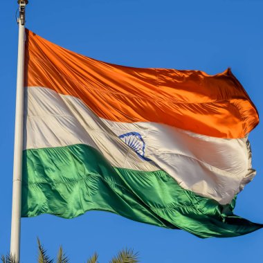 India flag flying high at Connaught Place with pride with plain white background, India flag fluttering, Indian Flag on Independence Day and Republic Day of India, tilt up shot, Har Ghar Tiranga