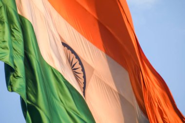 India flag flying high at Connaught Place with pride with plain white background, India flag fluttering, Indian Flag on Independence Day and Republic Day of India, tilt up shot, Har Ghar Tiranga