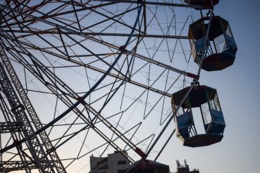 Delhi, Hindistan 'da Dussehra Mela sırasında çok renkli Dev Tekerlek' in yakın çekimi. Dev tekerlek salıncağının alt görüntüsü. Akşam vakti renkli kamaraları olan dönme dolap..