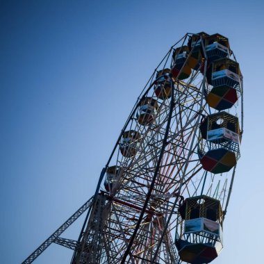Delhi, Hindistan 'da Dussehra Mela sırasında çok renkli Dev Tekerlek' in yakın çekimi. Dev tekerlek salıncağının alt görüntüsü. Akşam vakti renkli kamaraları olan dönme dolap..