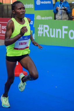 Yeni Delhi, Hindistan - 20 Ekim 2024 - Bitmek üzere olan maraton katılımcılarının bitiş çizgisini geçmek üzere olan Delhi Yarı Maratonu 2024