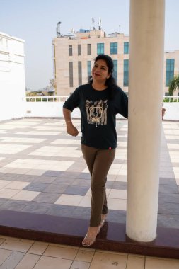 Fotoşop için poz veren genç ve güzel Hintli bayan, kendinden emin Asyalı kadın güneş ışığı altında fotoşop yapıyor.