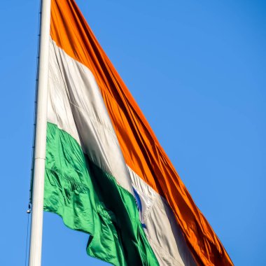 India flag flying high at Connaught Place with pride with plain white background, India flag fluttering, Indian Flag on Independence Day and Republic Day of India, tilt up shot, Har Ghar Tiranga