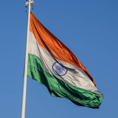 India flag flying high at Connaught Place with pride with plain white background, India flag fluttering, Indian Flag on Independence Day and Republic Day of India, tilt up shot, Har Ghar Tiranga