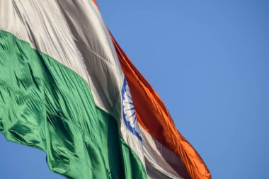 India flag flying high at Connaught Place with pride with plain white background, India flag fluttering, Indian Flag on Independence Day and Republic Day of India, tilt up shot, Har Ghar Tiranga