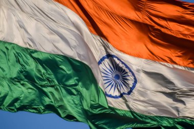 India flag flying high at Connaught Place with pride with plain white background, India flag fluttering, Indian Flag on Independence Day and Republic Day of India, tilt up shot, Har Ghar Tiranga