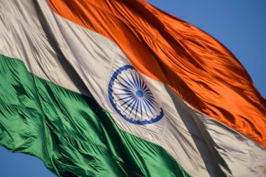 India flag flying high at Connaught Place with pride with plain white background, India flag fluttering, Indian Flag on Independence Day and Republic Day of India, tilt up shot, Har Ghar Tiranga