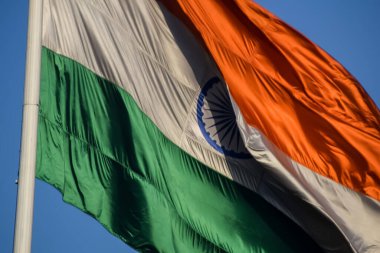 India flag flying high at Connaught Place with pride with plain white background, India flag fluttering, Indian Flag on Independence Day and Republic Day of India, tilt up shot, Har Ghar Tiranga