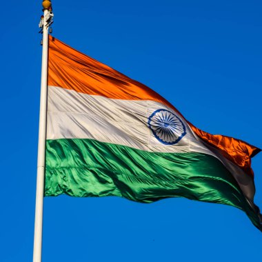 India flag flying high at Connaught Place with pride with plain white background, India flag fluttering, Indian Flag on Independence Day and Republic Day of India, tilt up shot, Har Ghar Tiranga