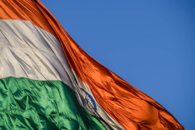 India flag flying high at Connaught Place with pride with plain white background, India flag fluttering, Indian Flag on Independence Day and Republic Day of India, tilt up shot, Har Ghar Tiranga