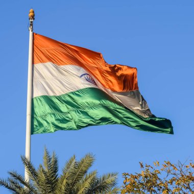 India flag flying high at Connaught Place with pride with plain white background, India flag fluttering, Indian Flag on Independence Day and Republic Day of India, tilt up shot, Har Ghar Tiranga