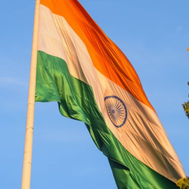 India flag flying high at Connaught Place with pride with plain white background, India flag fluttering, Indian Flag on Independence Day and Republic Day of India, tilt up shot, Har Ghar Tiranga