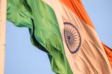 India flag flying high at Connaught Place with pride with plain white background, India flag fluttering, Indian Flag on Independence Day and Republic Day of India, tilt up shot, Har Ghar Tiranga
