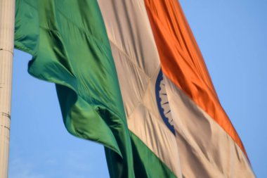 India flag flying high at Connaught Place with pride with plain white background, India flag fluttering, Indian Flag on Independence Day and Republic Day of India, tilt up shot, Har Ghar Tiranga