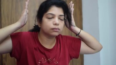 Evde yoga yapan genç Hintli bir kadın çevrimiçi yoga seansında güzel bir kız temel yoga pozisyonunda Asyalı bir kadın kapalı alanda yoga yapıyor. 