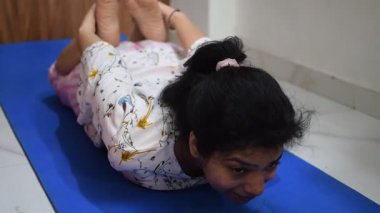 Evde yoga yapan genç Hintli bir kadın çevrimiçi yoga seansında güzel bir kız temel yoga pozisyonunda Asyalı bir kadın kapalı alanda yoga yapıyor. 