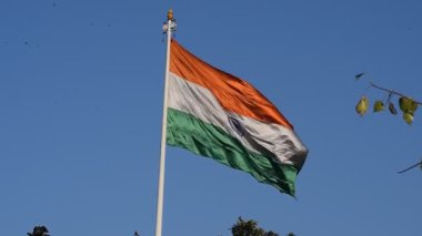 India flag flying high at Connaught Place with pride with plain white background, India flag fluttering, Indian Flag on Independence Day and Republic Day of India, tilt up shot, Har Ghar Tiranga
