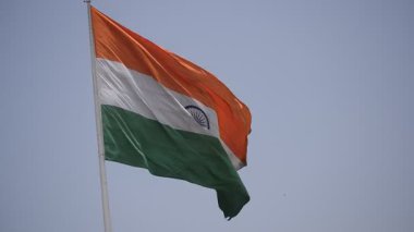 India flag flying high at Connaught Place with pride with plain white background, India flag fluttering, Indian Flag on Independence Day and Republic Day of India, tilt up shot, Har Ghar Tiranga