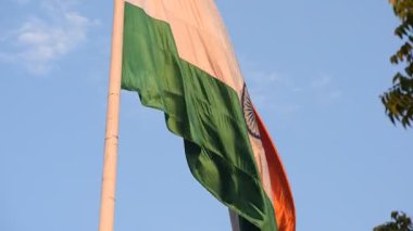 India flag flying high at Connaught Place with pride with plain white background, India flag fluttering, Indian Flag on Independence Day and Republic Day of India, tilt up shot, Har Ghar Tiranga