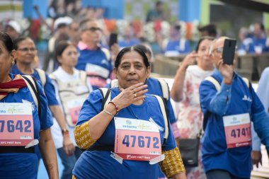 Yeni Delhi, Hindistan - 20 Ekim 2024 - Vedanta Delhi Yarı Maraton yarışına katılan yaşlılar maraton katılımcılarının bitiş çizgisini geçmek üzere oldukları Delhi Yarı Maratonu 2024