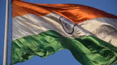 India flag flying high at Connaught Place with pride with plain white background, India flag fluttering, Indian Flag on Independence Day and Republic Day of India, tilt up shot, Har Ghar Tiranga