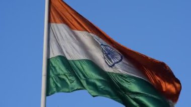 India flag flying high at Connaught Place with pride with plain white background, India flag fluttering, Indian Flag on Independence Day and Republic Day of India, tilt up shot, Har Ghar Tiranga