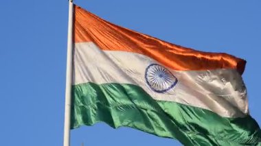 India flag flying high at Connaught Place with pride with plain white background, India flag fluttering, Indian Flag on Independence Day and Republic Day of India, tilt up shot, Har Ghar Tiranga