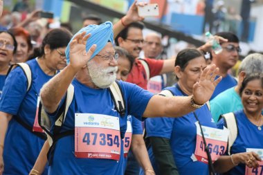 Yeni Delhi, Hindistan - 20 Ekim 2024 - Vedanta Delhi Yarı Maraton yarışına katılan yaşlılar maraton katılımcılarının bitiş çizgisini geçmek üzere oldukları Delhi Yarı Maratonu 2024