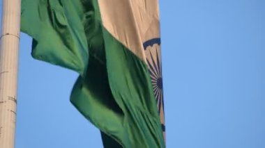 India flag flying high at Connaught Place with pride with plain white background, India flag fluttering, Indian Flag on Independence Day and Republic Day of India, tilt up shot, Har Ghar Tiranga