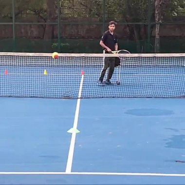 Delhi, Hindistan, 17 Şubat 2025 - Maha Open için kil tenis kortunda antrenörlük yapan genç tenisçiler, yaklaşan turnuva için küçük tenis oyuncuları antrenman yapıyor