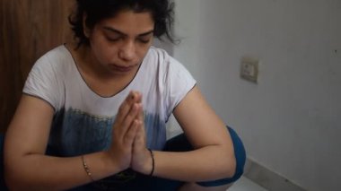 Evde yoga yapan genç Hintli bir kadın çevrimiçi yoga seansında güzel bir kız temel yoga pozisyonunda Asyalı bir kadın kapalı alanda yoga yapıyor. 