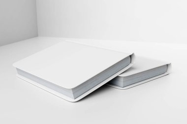 Stack of White Blank Books Displayed on Minimalist Background clipart