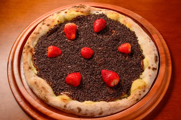 stock image Strawberry pizza with chocolate on wooden table.