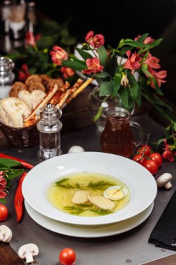 Lezzetli tavuk çorbası dolu beyaz bir kase..