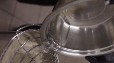 Senior professional chef kneading floured dough at bakery, mature retiree enjoying hobby making homemade bread using traditional recipe isolated on black background close up. High quality footage