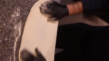 Italian chef making margaritta pizza with tomato sause and mozzarella, traditional food in italy, high kitchen gastrobar restaurant, street food delivery. High quality FullHD footage