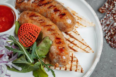 Tabakta ızgara lezzetli sucuklu sosis var. Yüksek kalite fotoğraf