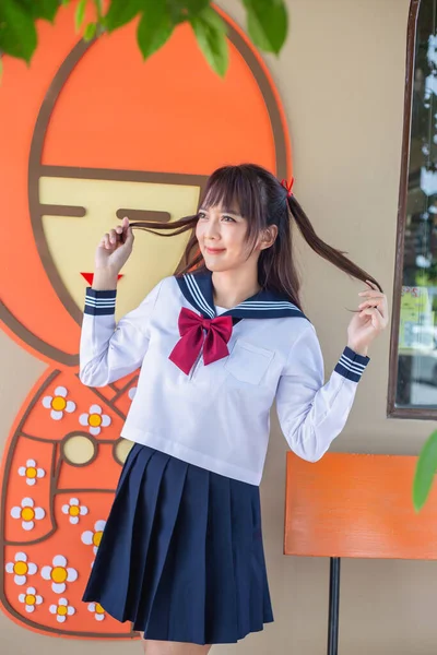 Woman Wearing Japanese School Uniform Stands Cute Pattern Background — Stock Photo, Image