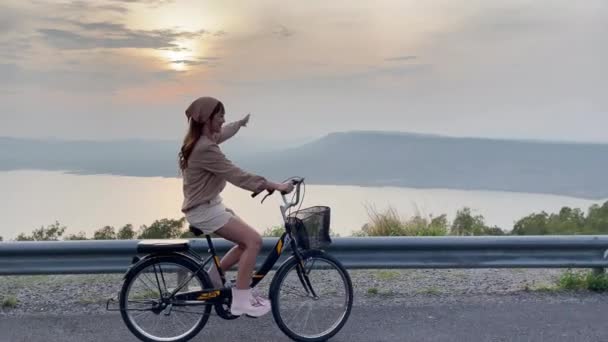 Woman Wearing Cute Outfit Riding Bicycle Sunset Mountains River Wind — Stock Video