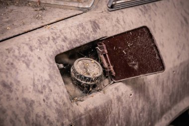 Üzerinde toz ve kir olan eski bir arabanın yakıt deposu. Klasik araba.