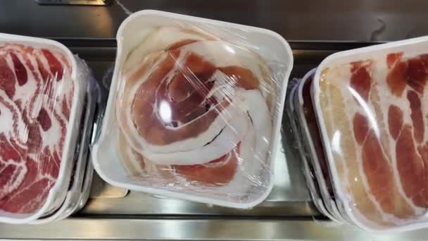 在餐馆里 猪肉和牛肉片包在一条不断移动的传送带上 准备吃 — 图库视频影像