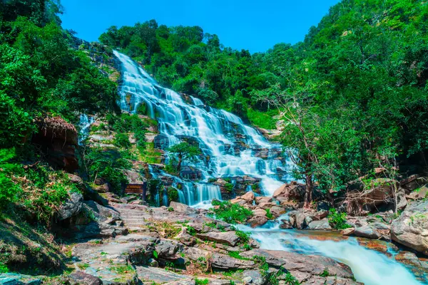 Amazing deep forest big waterfall at Mae Ya waterfall, Doi Inthanon national park Chiangmai, Thailand. Translate text \