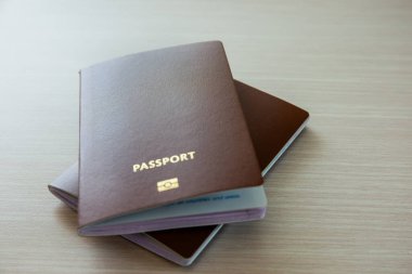 Passport for International travel and business laid out on a wooden background. Copy space background clipart