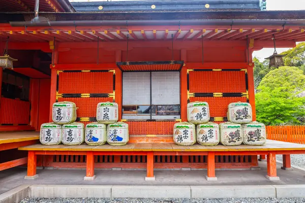 stock image Fujinomiya, Japan  April 8, 2024: People visit Fujisan Hongu Sengen Taisha Shinto Shrine where cherry blossoms are blooming on a rainy day at Shizuoka, Japan.