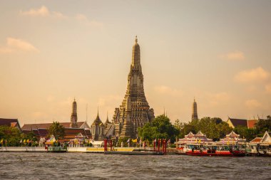 Wat Arun with the Chao Phraya River in front of it is a popular destination for tourists around the world. Bangkok Thailand clipart