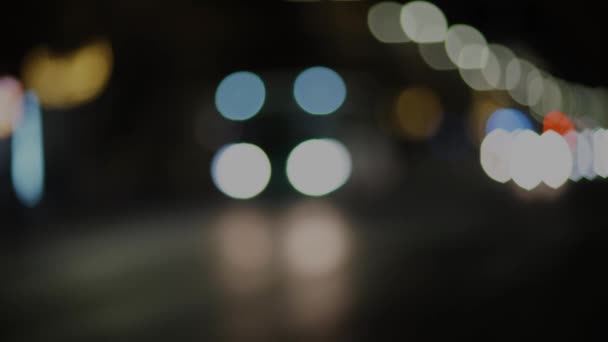 Blurred footage of transport. Blur of city lights along the road, out of focus light at night. Traffic on the road of the night city, beautiful background