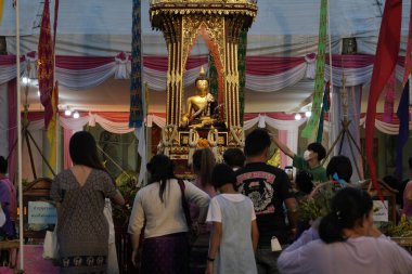 CHIANG MAI THAILAND - 16 Mayıs 2023: Inthakin Festivali veya Sai Khan Dok geleneği Chiang Mai 'nin Chiang Mai, Tayland' daki Wat Chedi Luang 'daki sütununa çiçek sunan vatandaşlardır..